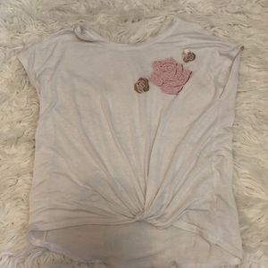 White t-shirt with paint rose in the top right corner